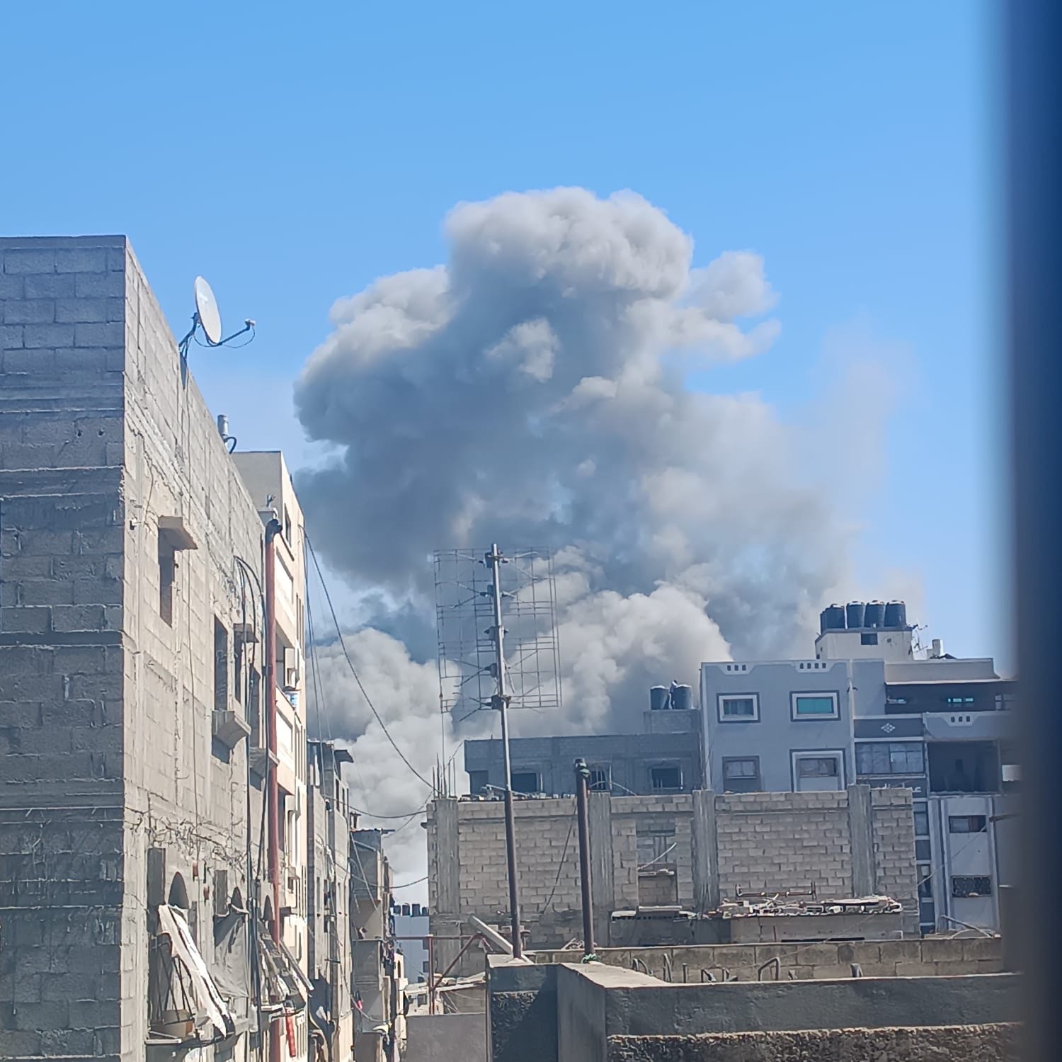 Smoke rises above Gaza buildings after bombardment; tied to Help Gaza family evacuate