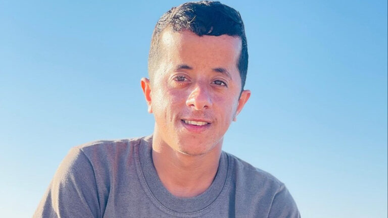 Hakim smiling despite hardship; image tied to Help Gaza family shelter.