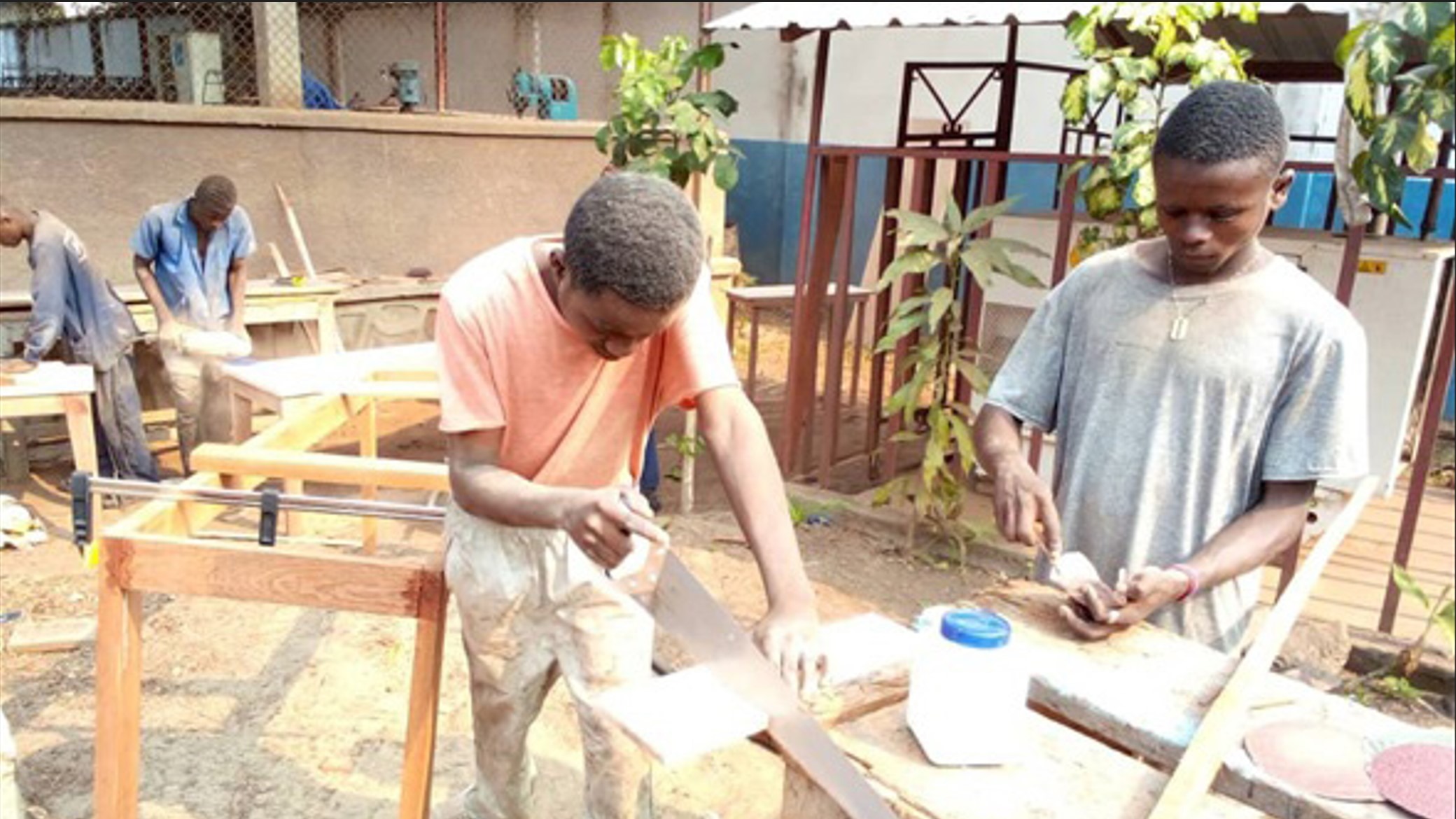 Young boys in Congo learning carpentry skills.