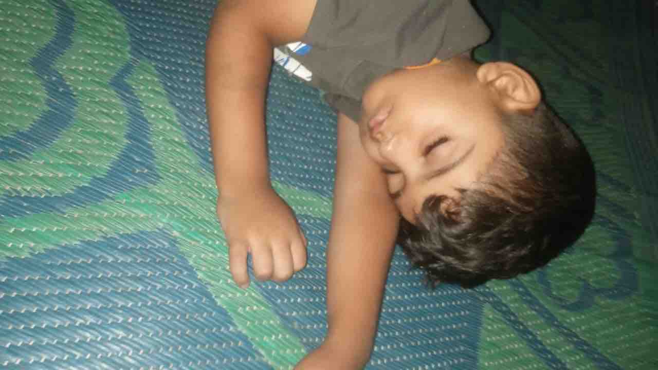 Child resting on mat in Gaza; image for Gaza child medical aid.